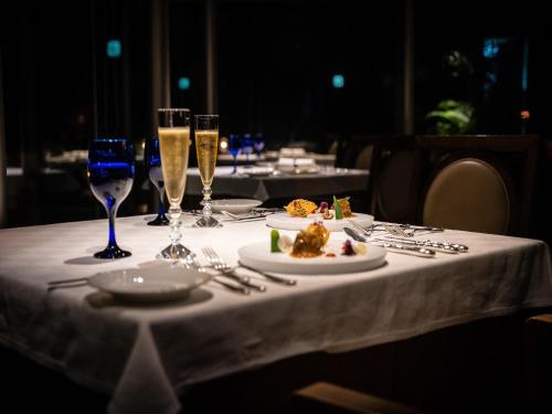 a table with glasses of champagne and a plate of food at Oriental Hills Okinawa in Onna
