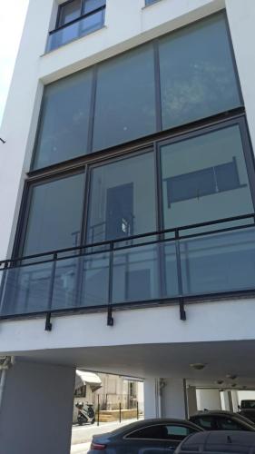 a building with glass windows on the side of it at LOFT Ceremi in Marmara