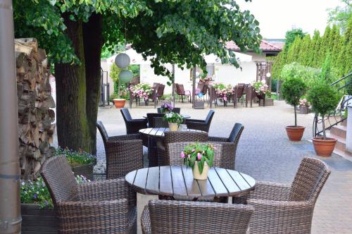 a group of tables and chairs with flowers on them at Gościniec Sucholeski in Suchy Las