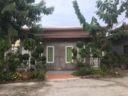 a house with a lot of plants in front of it at Nava Resort in Nakhon Nayok