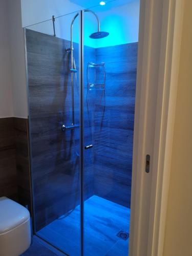 a shower with a glass door in a bathroom at Luxmarì Hotel & Spa in Castellammare del Golfo
