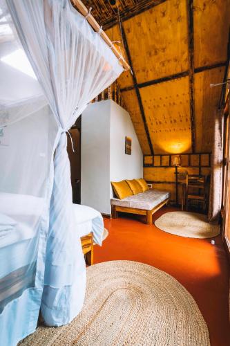 a room with two beds and a couch in a room at Samora River Lodge in Arusha