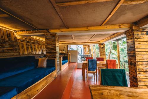 a room with a couch and a table and chairs at Samora River Lodge in Arusha