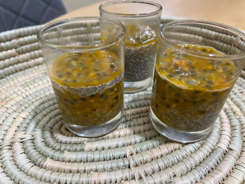 three glasses of food sitting on top of a wicker table at Samora River Lodge in Arusha