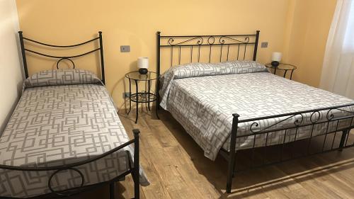 two beds sitting next to each other in a bedroom at Appartamento La Ginestra in Gozzano