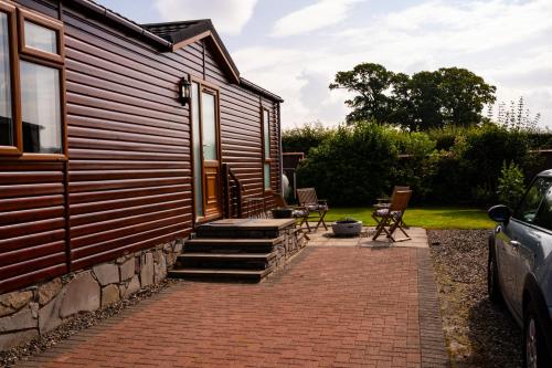 a brick walkway leading to the side of a house at Luxury Lodge in Forfar