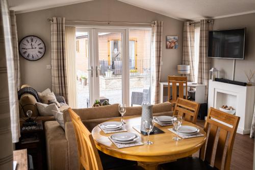 a living room with a table and a couch at Luxury Lodge in Forfar