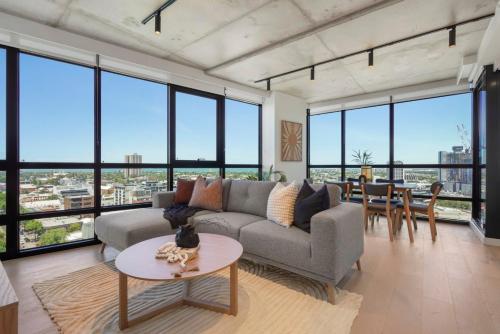 a living room with a couch and a table at Deluxe Living in Southbank, Parking Available T&Cs in Melbourne