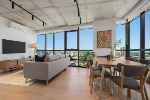 a living room with a couch and a table at Deluxe Living in Southbank, Parking Available T&Cs in Melbourne