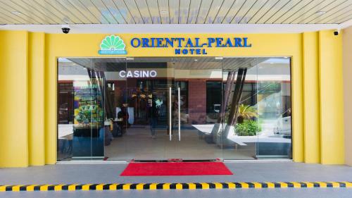 an urban park hotel entrance with a red rug in front at Centennial Inn in Kawit