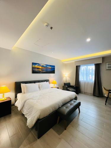a bedroom with a large bed in a room at Centennial Inn in Kawit
