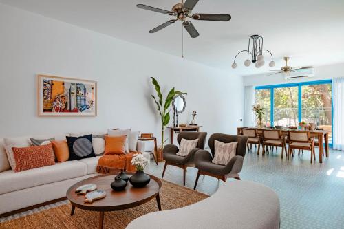 a living room with a couch and a table at Baia Luxe 3BHK Villa Pool & Jacuzzi, Mandrem Goa in Mandrem