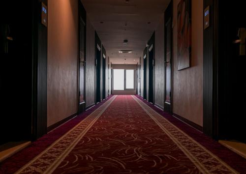 an empty corridor with a red carpet in a building at Best Western Plus Jeddah Hotel Madinah Road in Jeddah