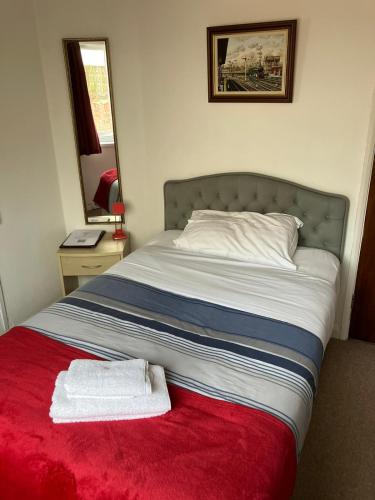 a bed with two towels sitting on top of it at The Great Western B&B in Paignton