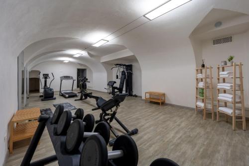 a gym with treadmills and exercise bikes in a room at Corte Novella Hotel & Residence in Brescia