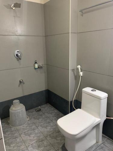 a bathroom with a toilet and a shower at Hotel BCP Suites in Bangalore