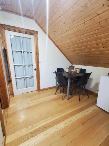 a dining room with a table and chairs and a window at Rail Trail Retreat Loft in Alexandra