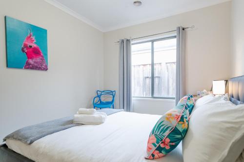 a bedroom with a bed and a large window at Point Cook Spacious Maison in Point Cook