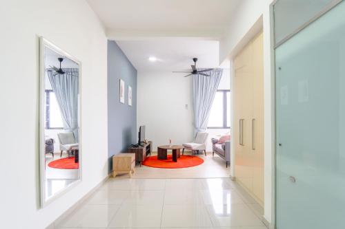 a hallway with a living room with a table at Encorp Strand Residences by Airhost in Kota Damansara