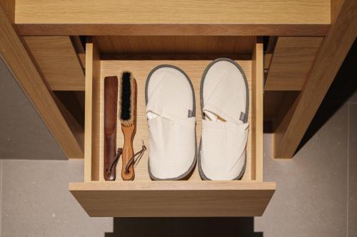 a pair of shoes and a pair of brushes in a wooden holder at Kinock in Gyeongju