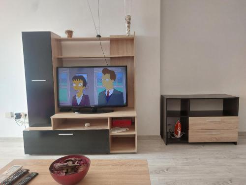 a living room with a flat screen tv on a entertainment center at Studio Sarafovo in Burgas City