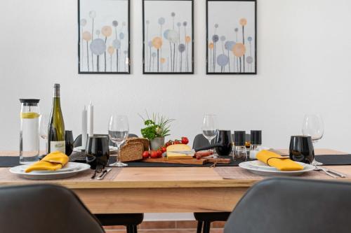 a dining room table with fruits and wine glasses at Dat Schniederhus in Ehrenburg