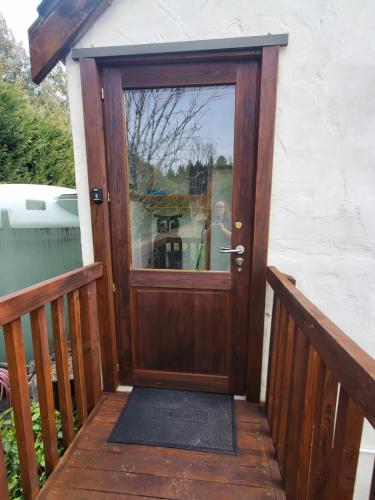 a wooden door with a glass window on a porch at Rail Trail Retreat Loft in Alexandra