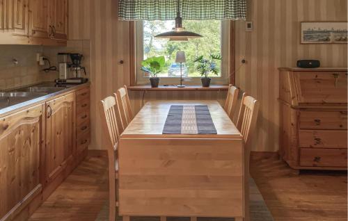a kitchen with a wooden table and chairs and a window at 2 Bedroom Lovely Home In Varberg in Varberg