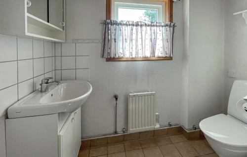 a bathroom with a sink and a toilet and a window at 2 Bedroom Lovely Home In Varberg in Varberg