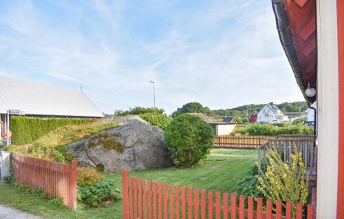 a yard with a fence and a large rock at 4 Bedroom Gorgeous Home In Sölvesborg in Sölvesborg