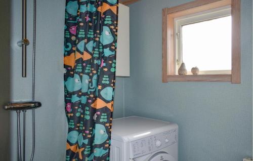 a laundry room with a washing machine and a window at 4 Bedroom Gorgeous Home In Sölvesborg in Sölvesborg
