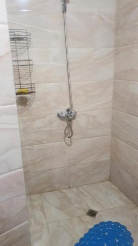 a shower with a hose attached to a wall at Studio Sarafovo in Burgas