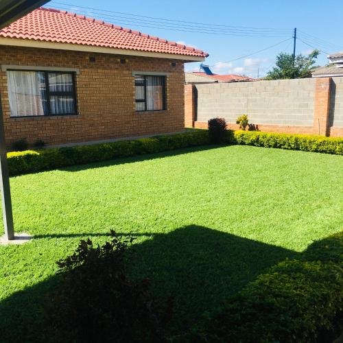 a yard in front of a brick house at Kwakwethu in Bulawayo