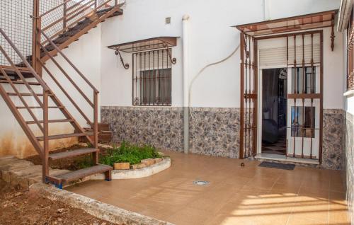 an entrance to a building with a staircase and a door at 2 Bedroom Nice Home In Alcalá Del Río in Alcalá del Río