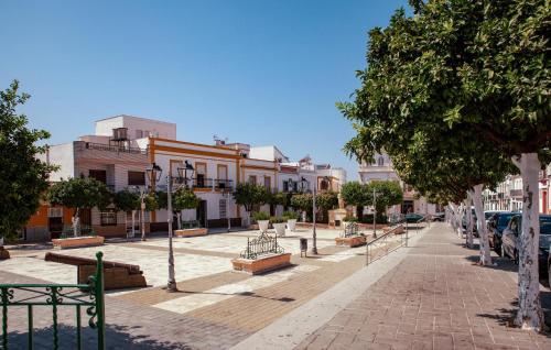 a street with benches and trees in a city at 2 Bedroom Nice Home In Alcalá Del Río in Alcalá del Río