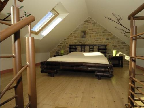 a bedroom with a bed in a attic at Domaine de Kerzuat in Plouarzel
