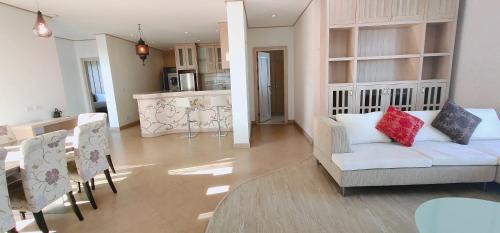 a living room with a white couch and a table at Ratana Hotel Chalong in Rawai Beach