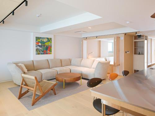 a living room with a couch and a table at B'amu Hotel in Busan