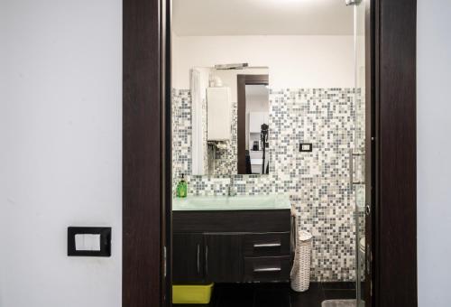 a bathroom with a sink and a mirror at Spinola Palace Apartment in Genoa