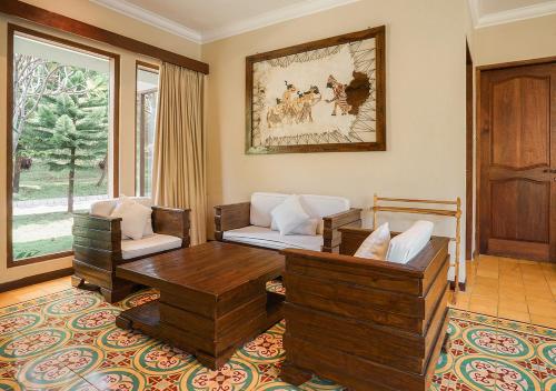 a living room with two chairs and a table at Shanaya Resort Malang in Malang