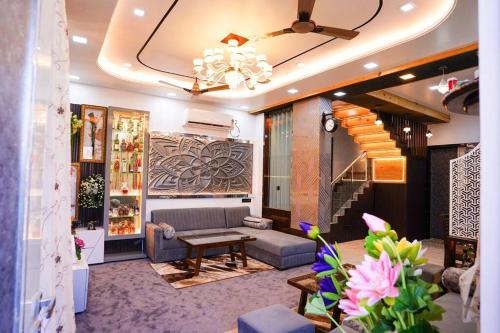 a living room with a couch and a table at BluStone By The StayCationer in Malavli