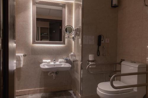 a bathroom with a toilet and a sink at Best Western Plus Jeddah Hotel Madinah Road in Jeddah