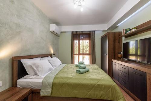 a bedroom with a bed with a teddy bear on it at Vutovi's corner made with care in Bansko