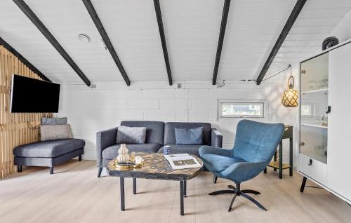 a living room with a couch and a table and chairs at 2 Bedroom Amazing Home In Thisted in Thisted
