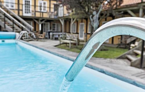 a swimming pool with a water shooting out of it at 2 Bedroom Awesome Apartment In Svaneke in Svaneke