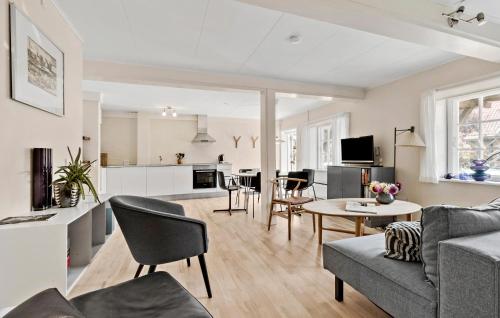 a living room with a couch and a table at 2 Bedroom Awesome Apartment In Svaneke in Svaneke