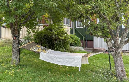 a hammock hanging from a tree in a yard at 3 Bedroom Nice Home In Motala in Motala