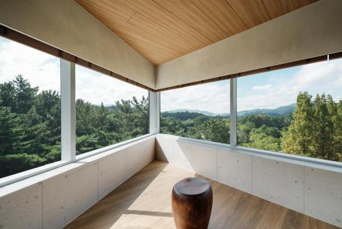 a room with large windows and a wooden floor at Kinock in Gyeongju