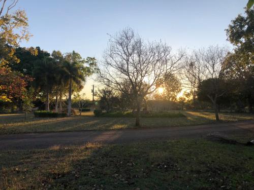 a road in a park with the sun setting at Shauna's Shack in Katherine