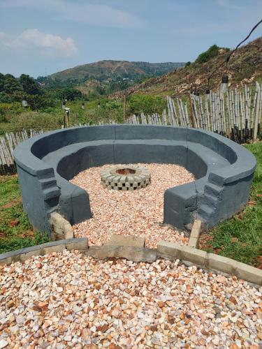 a fire pit in the middle of a yard at Thatched Cottage Jinja in Jinja